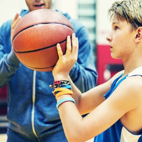 a kid holding a basketball
