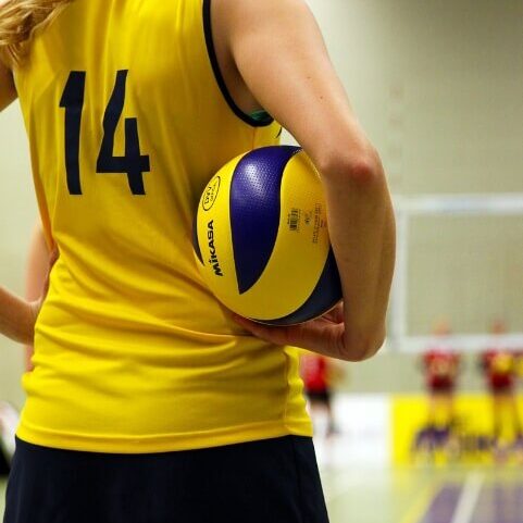 a volleyball player holding a volleyball